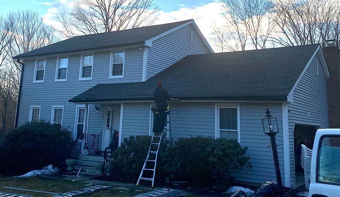 worker-installing-gutter-on-the-house-roof